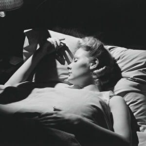 Young woman sleeping in bed (B&W)