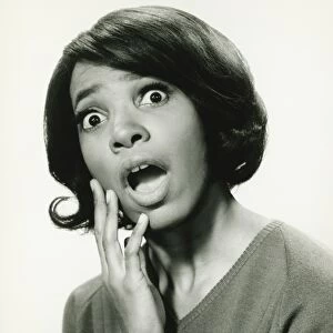 Young woman with surprised expression, (B&W), close-up