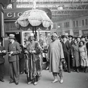 African ruler leaves thoughtfully to review under Royal umbrella. The Alake of Abeokuta