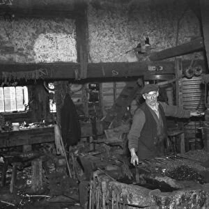 The blacksmith at work in the Westerham Forge. 1935