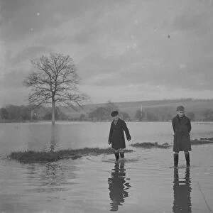 Two boys paddle through the floods in Yalding, Kent. 1936