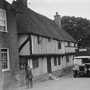 A bus passing a pretty cottage in Hollingbourne, Kent. 1935