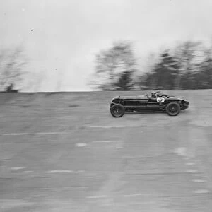 Captain Sir Henry Birkin in his car speeding around the Brooklands track at the