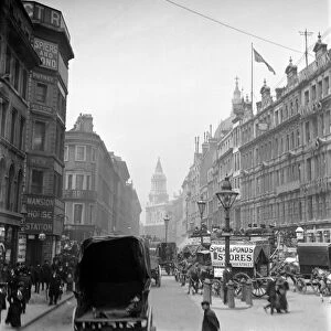 London street scene. The edge of St. Pauls Cathedral looking down Queen Victoria Street