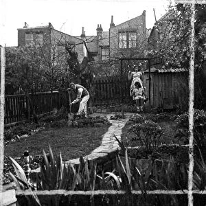 Man Gardening, while children play on swing 1946 [no caption, location or date]