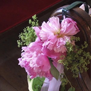 Paeonies and alchemilla mollis as pew end decoration, for summer wedding in country
