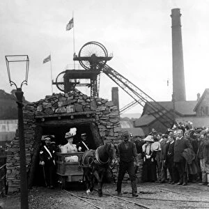 Queen Mary is led out of a coal mine by a miner and pit pony during a Royal visit