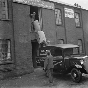 Workmen loading up a delivery van from Platt Mill, Borough Green, Kent with sacks