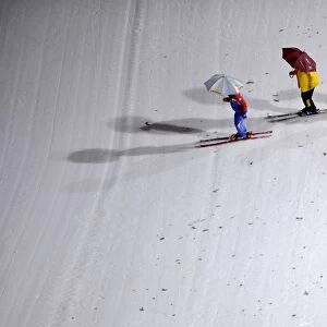 Workers prepare the slope of the Large Hill individual ski jumping in the World Ski