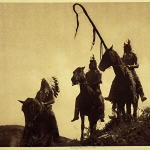 Apsaroke war group. The warrior on the right holds the curved stick of one of the tribal military organizations. This stick was planted in the ground at the decisive moment of the fight, like a banner behind which its wearer pledged not to retreat