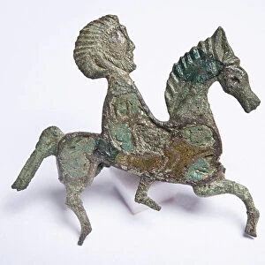 Bronze brooch in the shape of a horse and rider with inlaid enamel (copper alloy enamel)
