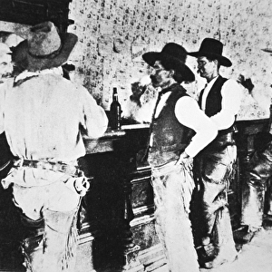 Cowboys drinking in a Texas saloon, c. 1890 (b / w photo)