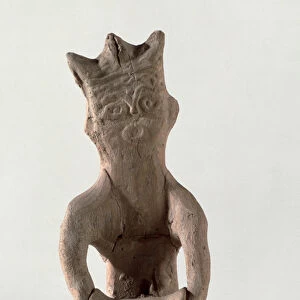 Cross-legged figure with an object thought to be a drum, from Susa, Iran