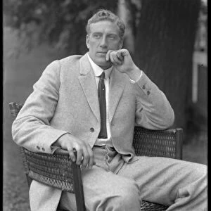 English boxer William Thomas Wells (Bombardier Billy Wells), posed seated in a tweed suit