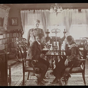 Francis Wilson and his daughter playing chess in the dining room of their residence in
