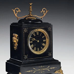 A mantle clock of black composition stone, with incised decoration, with legs