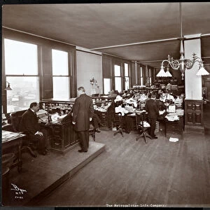 Men and women working at desks in an office at the Metropolitan Life Insurance Co