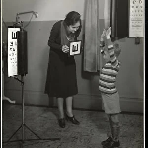 Nurse and a boy patient having an eye test at the New York Association for the Blind
