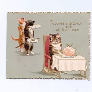 A Victorian greeting card of a cat seated at a table in front of a Christmas pudding
