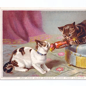 A Victorian greeting card of two kittens pulling a Christmas cracker, c
