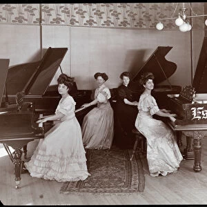 Four women seated at pianos at the Estey Piano Corporation, 1908 (silver gelatin print)