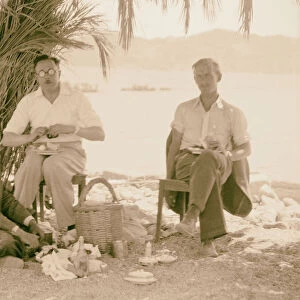 Camp Petra Photograh David Whiting two men eating outdoors