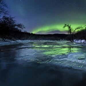 Aurora Borealis over a frozen Kvannelva River, Troms, Norway