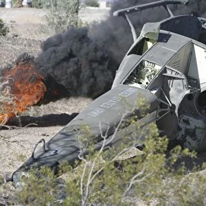 Black smoke rises to the air from a simulated wreckage of a downed UH-1N Huey