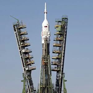 Launch scaffolding is raised into place around the Soyuz rocket