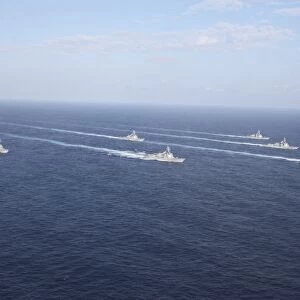 Military ships transit the Philippine Sea in formation