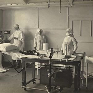Two nurses and a doctor in x-ray room at King George Military Hospital, London, 1915