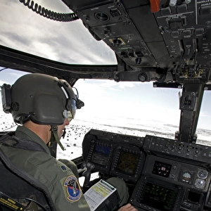 Pilot of a CV-22 Osprey goes over his instruments in the cockpit