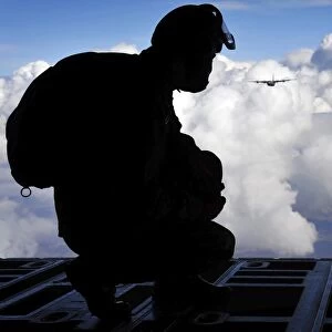 A Romanian paratrooper awaits his signal to jump out of a C-130J Super Hercules