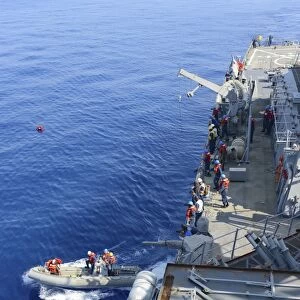 Sailors execute rescue operations in a rigid-hull inflatable boat