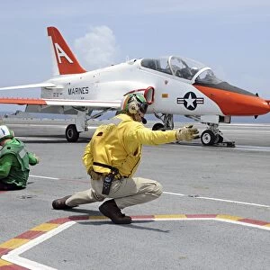 A shooter aboard the aircraft carrier USS George H