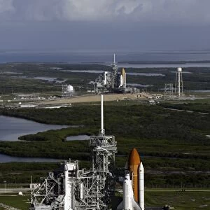 Space Shuttle Atlantis and Endeavour sit on their launch pads at Kennedy Space Center