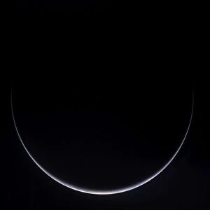 A sun-illuminated crescent of Earth around Antarctica