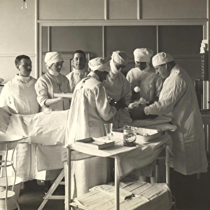 Surgeons and nurses tending to a patient at King George Military Hospital, London, 1915