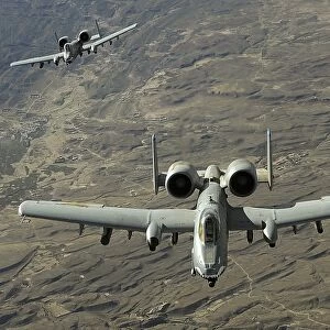 A two-ship A-10 Thunderbolt II formation flies a combat mission over Afghanistan