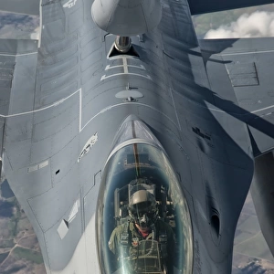 A U. S. Air Force F-16C Fighting Falcon receives in-flight refueling