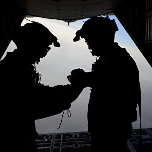 U. S. Air Force loadmasters fold the American flag aboard an HC-130 Hercules