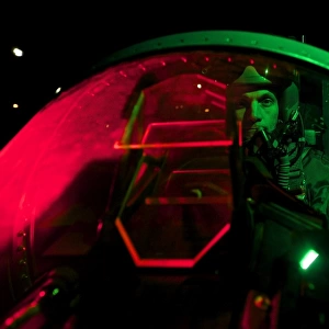 A U. S. Air Force pilot sits inside the cockpit of a F-15C Eagle
