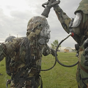 U. S. Air Force Soldier decontaminates an Airman