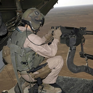 U. S. Marine test firing an M240 heavy machine gun on the back of a MV-22B Osprey