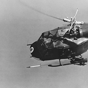 A UH-1 helicopter gunship fires a 2. 75-inch rocket, Vietnam War, 1969
