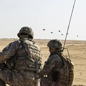 UH-60 Black Hawk helicopters prepare to airdrop soldiers in Kuwait
