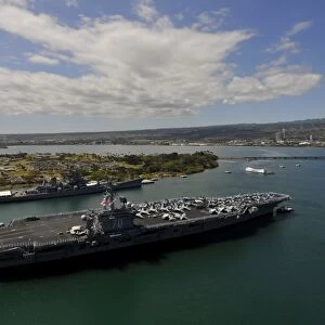 USS Carl Vinson passes the USS Missouri Memorial in Pearl Harbor