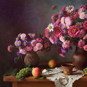 With bouquets of asters and grapes