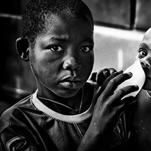 Quenching his brother´s thirst with a frozen water bag - Benin