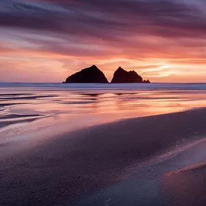 Holywell Bay, low tide at sunset, Carters Rocks and reflections, near Newquay, Cornwall, UK. April 2017